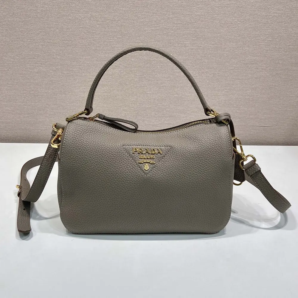Side angle showing shoulder strap and compact shape of Prada Women Small Leather Bag-Clay Gray