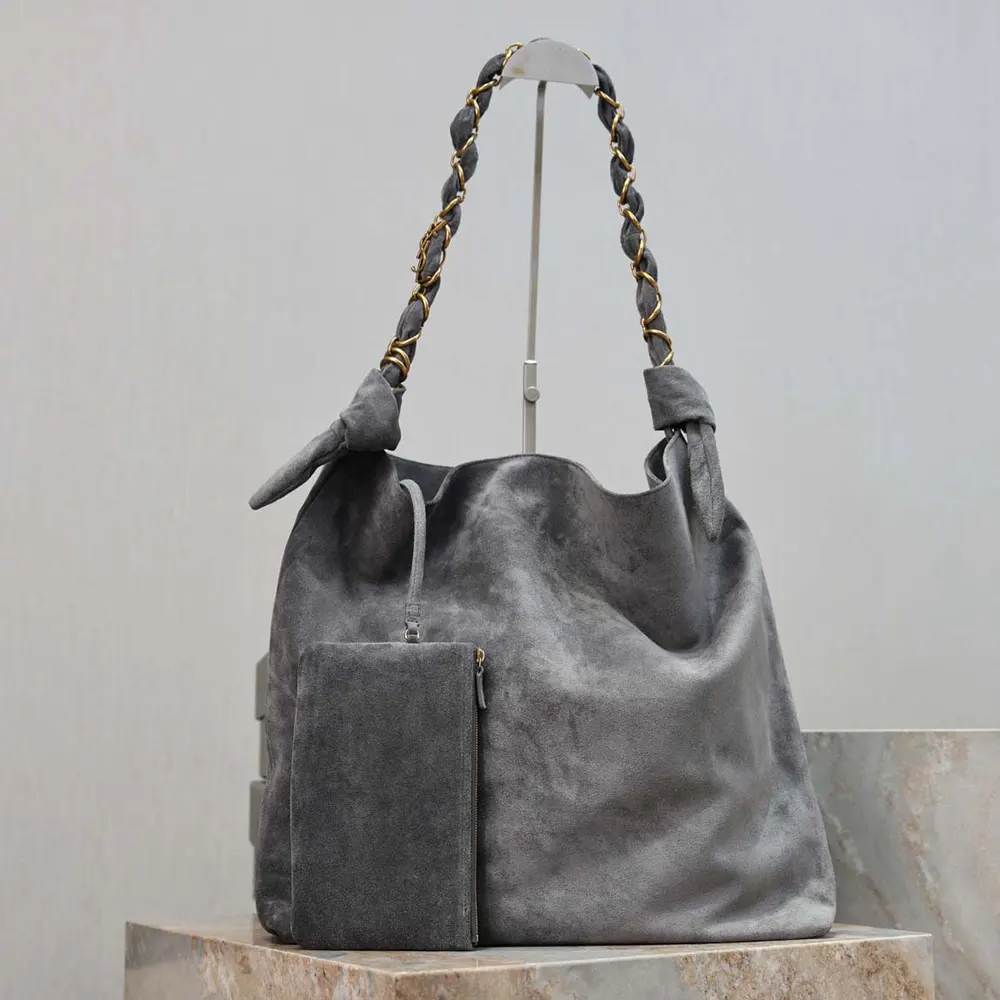 Close-up of gold YSL logo and suede texture on Amalia bag