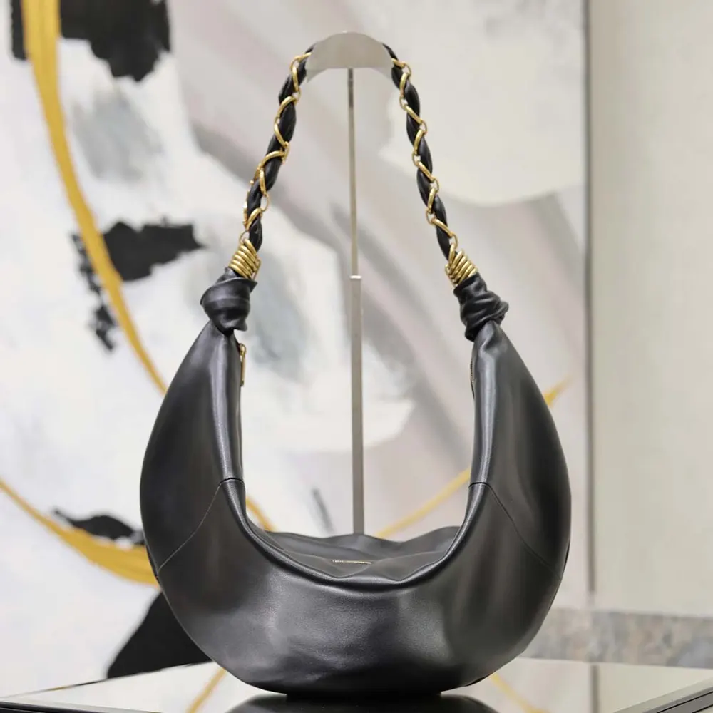 Close-up of gold YSL logo hardware on Amalia Small Hobo black lambskin bag