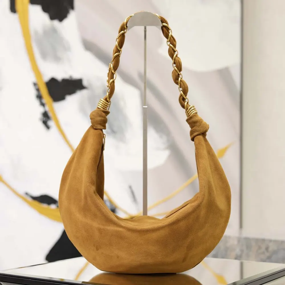 Close-up of gold-tone YSL logo on Amalia Small Hobo brown lambskin