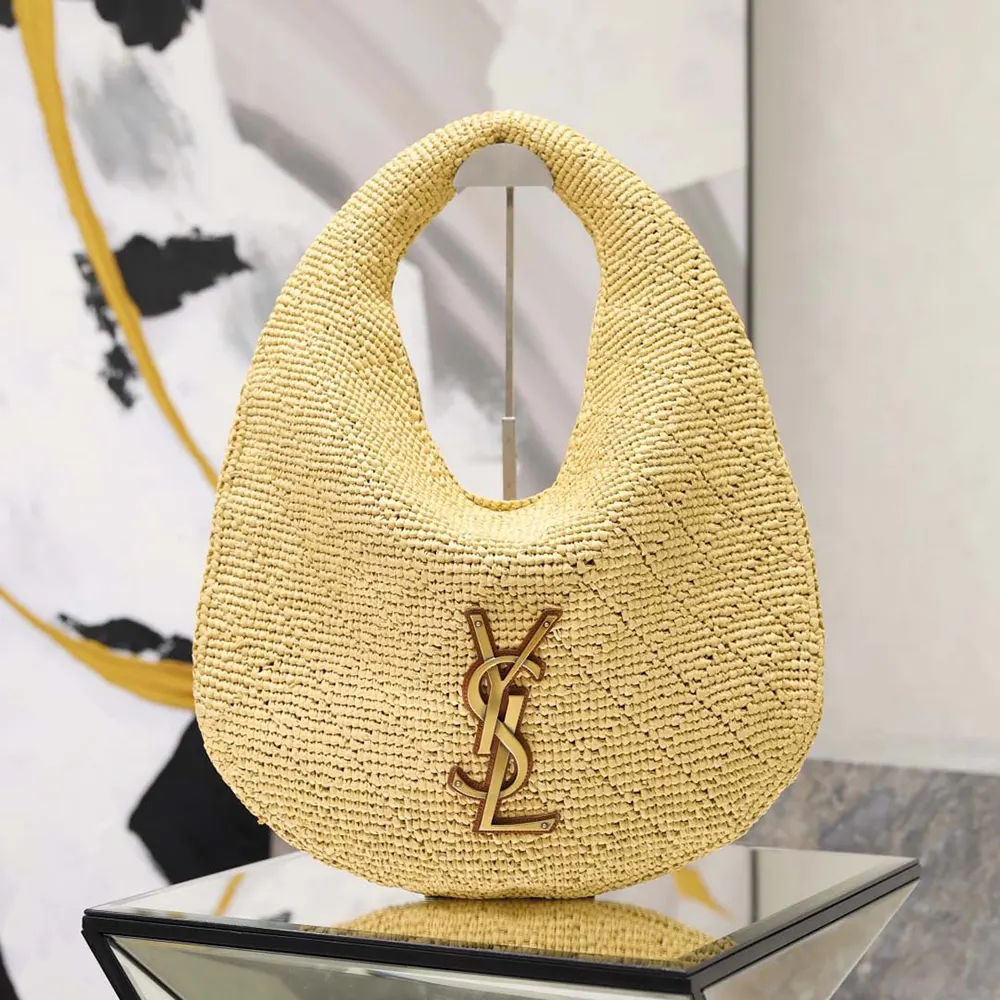 Close-up of gold YSL hardware on Icare Hobo In Raffia