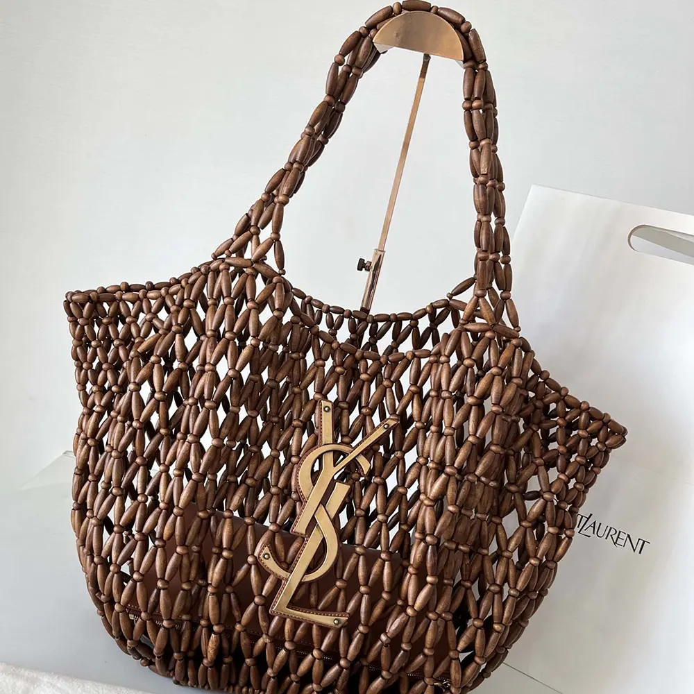 Close-up of gold-tone YSL hardware on wood bead bag