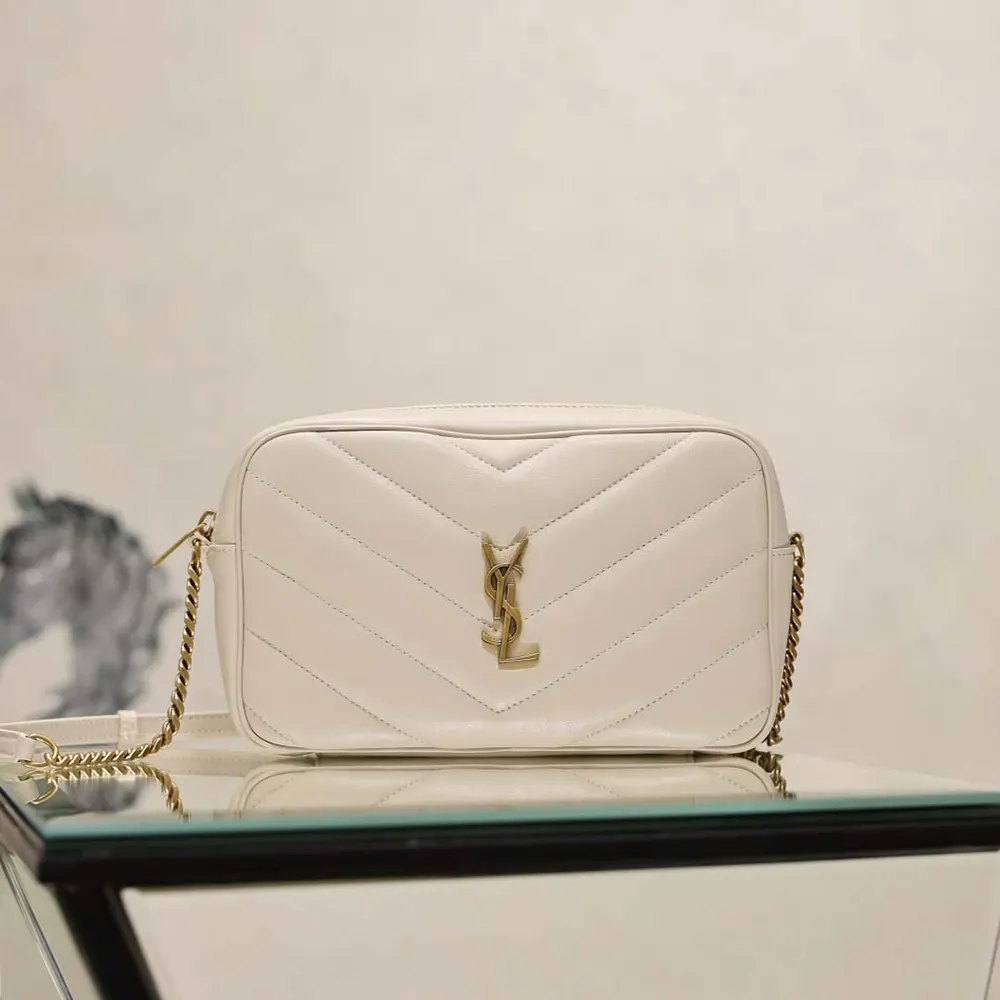 Close-up of gold YSL logo and matelassé leather texture on Saint Laurent bag