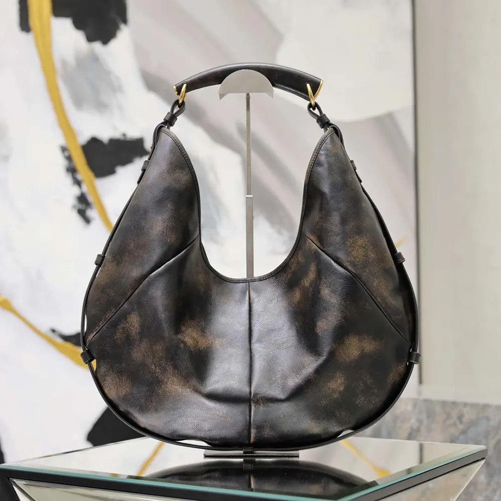Side angle showing shoulder strap and silhouette of Saint Laurent YSL Mombasa bag