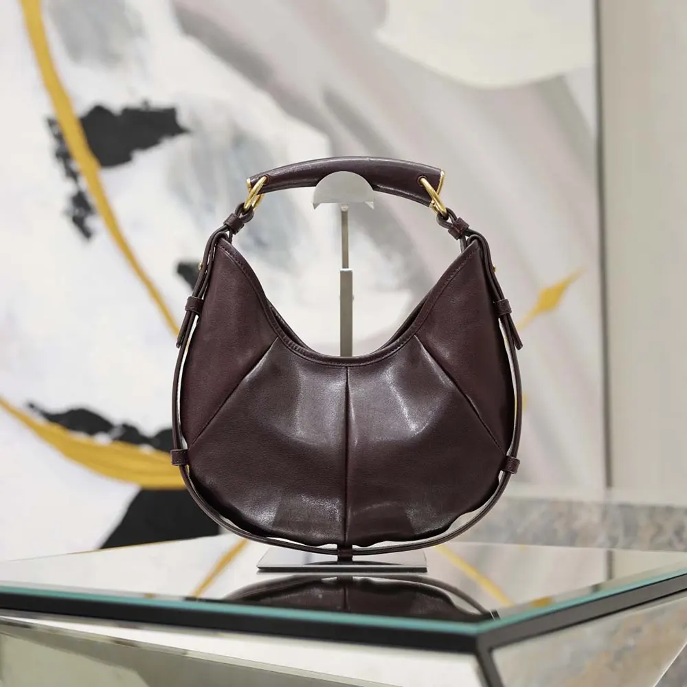 Close-up on gold YSL logo hardware of Mombasa Small bag