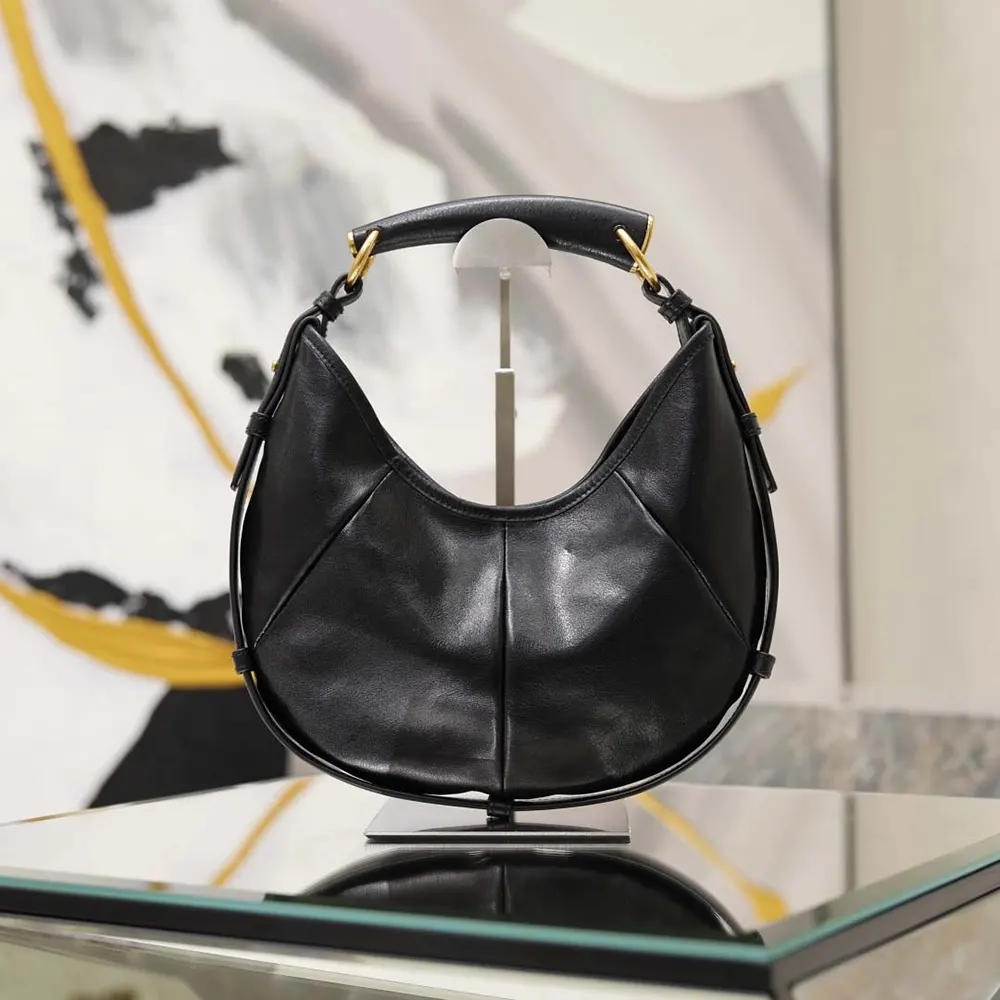 Close-up of gold YSL logo hardware on Mombasa Small leather bag