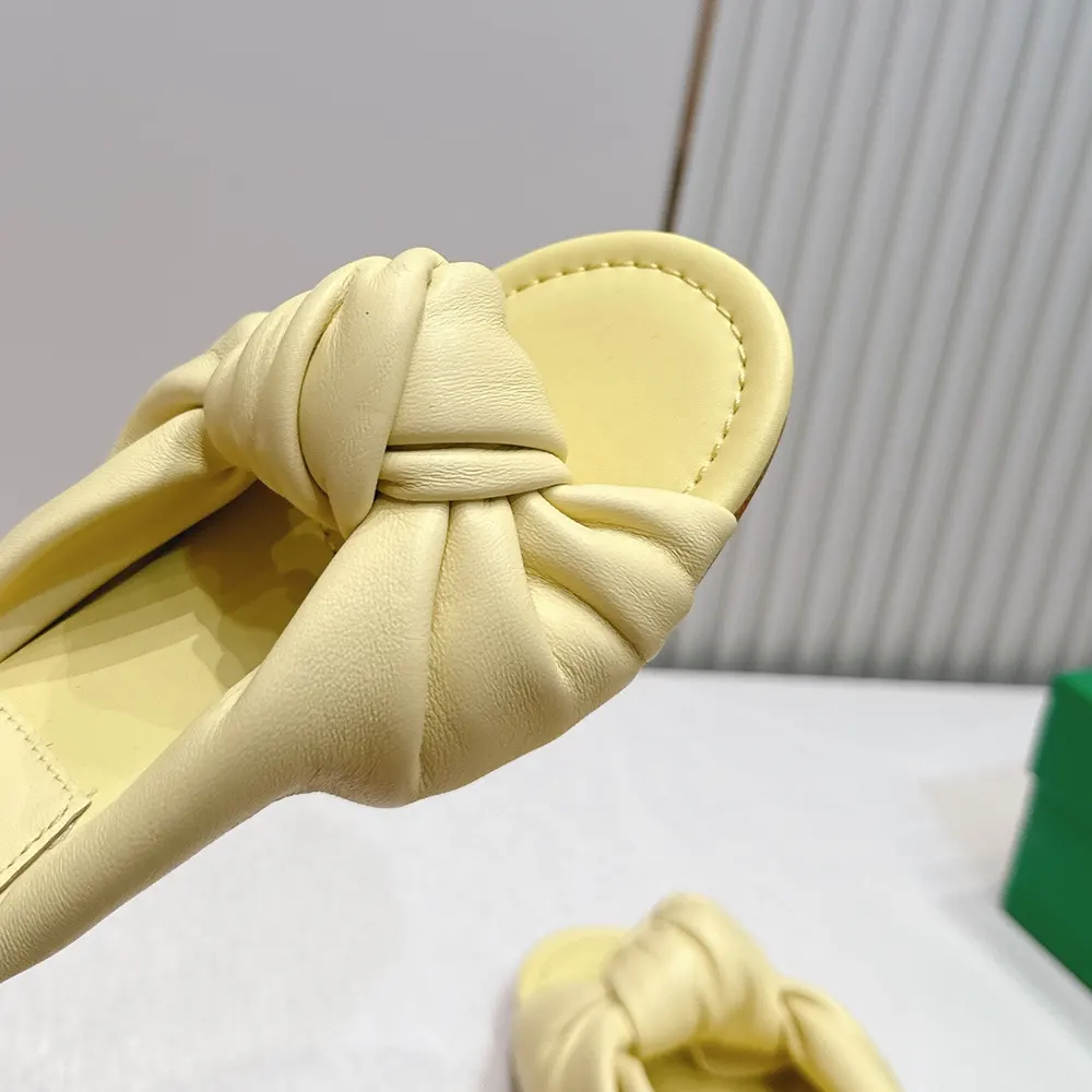 Overhead view of Bottega Veneta Women Lagoon Flat Slide Sandals in yellow