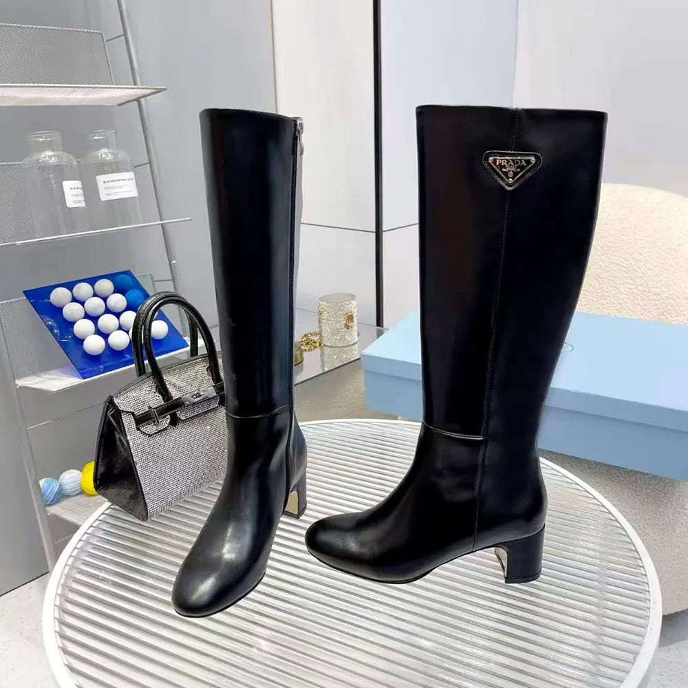 Rear angle showing silhouette and heel detail of Prada Women Brushed Leather Boots