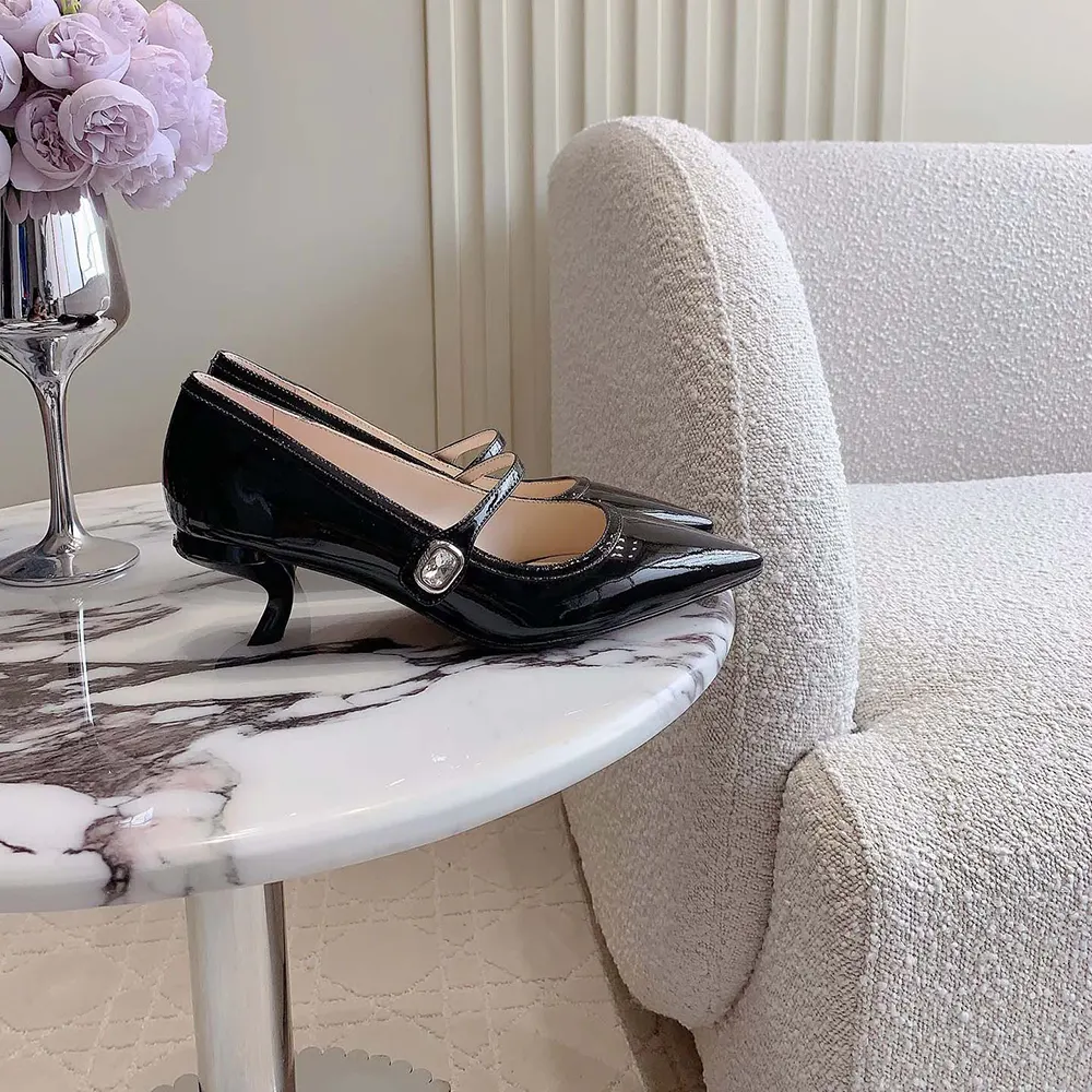 Close-up of Virgule signature buckle on Roger Vivier Mary Jane mules