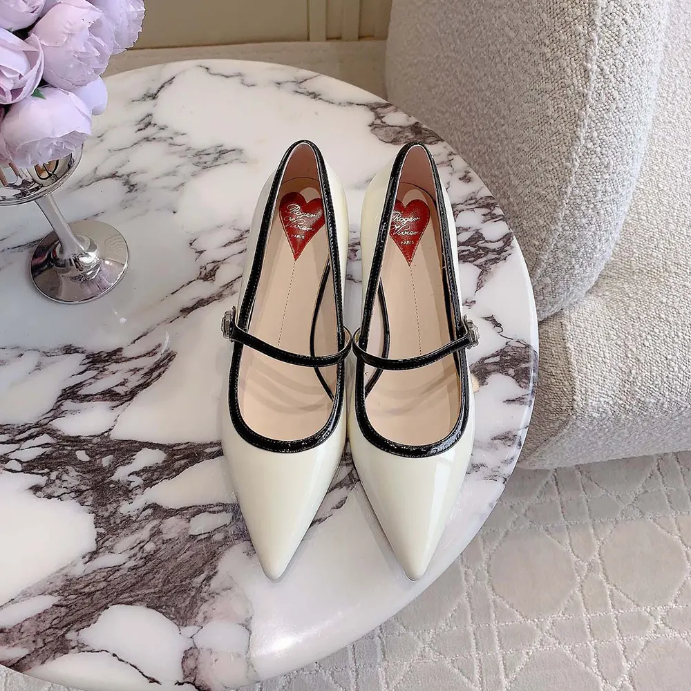 Overhead shot showing white patent leather and 55mm heel on Roger Vivier mules