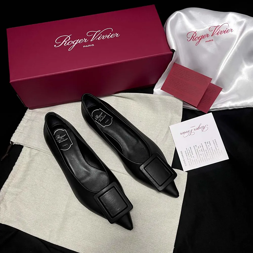 Side profile showing sleek silhouette of Roger Vivier black leather ballerinas