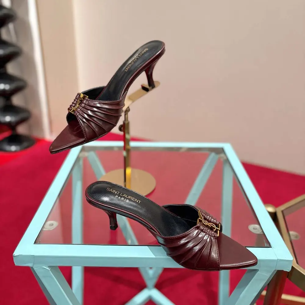 Close-up on YSL gold-tone hardware detail on Bordeaux leather mule