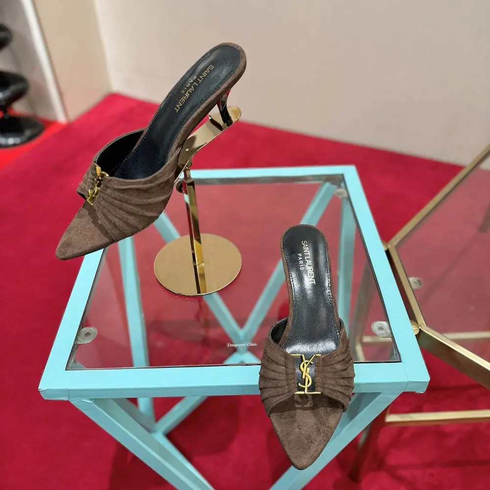 Close-up of gold YSL logo on Babylone mules in dark brown suede