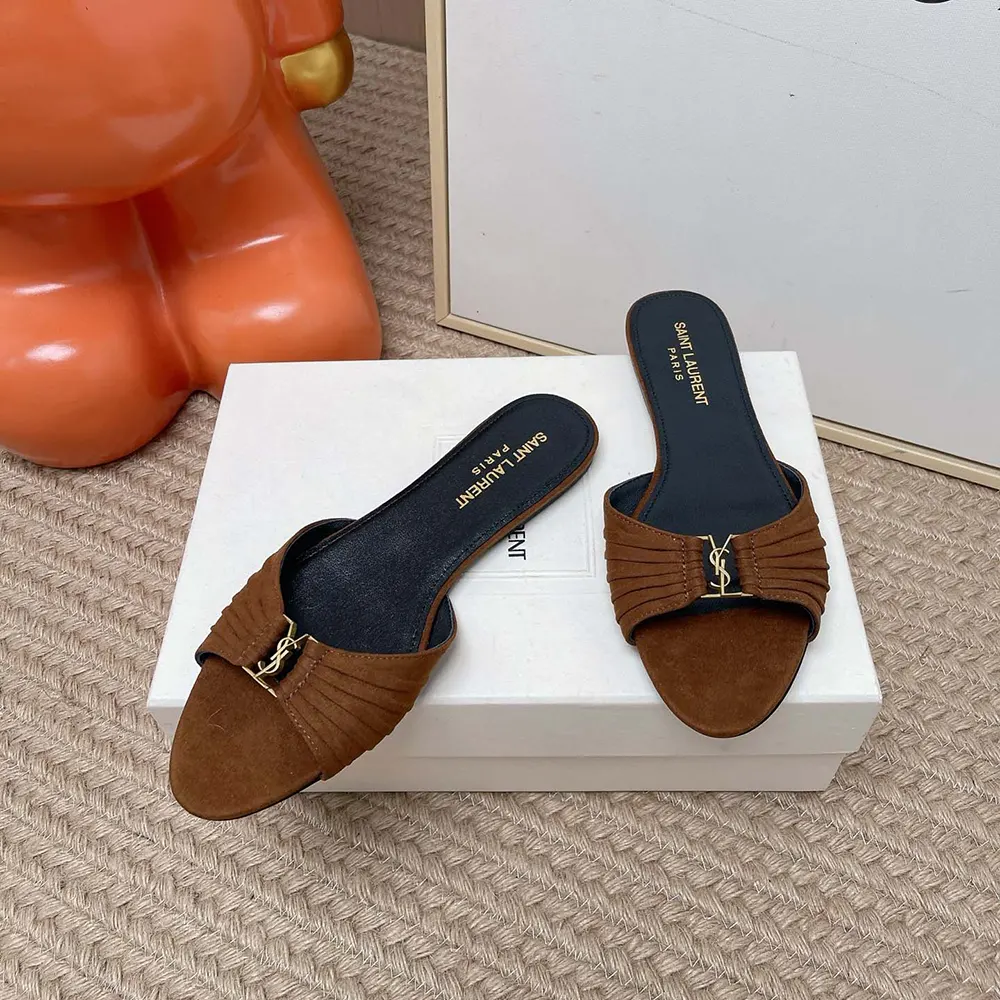 Close-up of gold YSL logo on Saint Laurent Babylone Slides