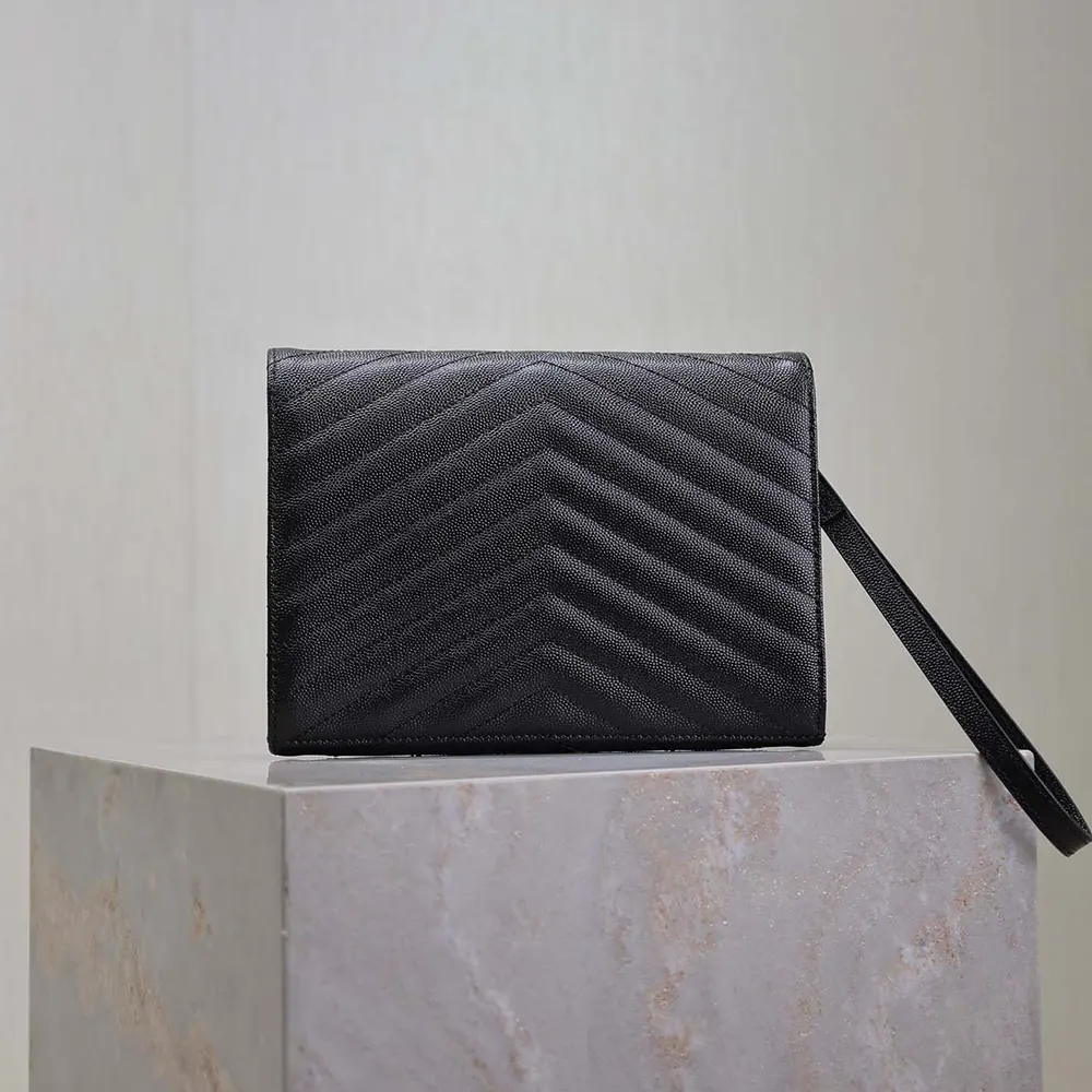 Side angle showing grain texture and flap closure on Saint Laurent pouch