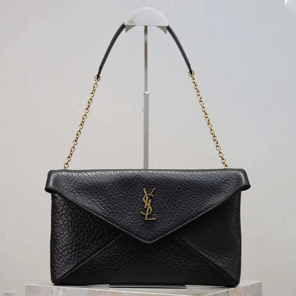 Close-up of YSL monogram and gunmetal chain on Cassandre Pouch