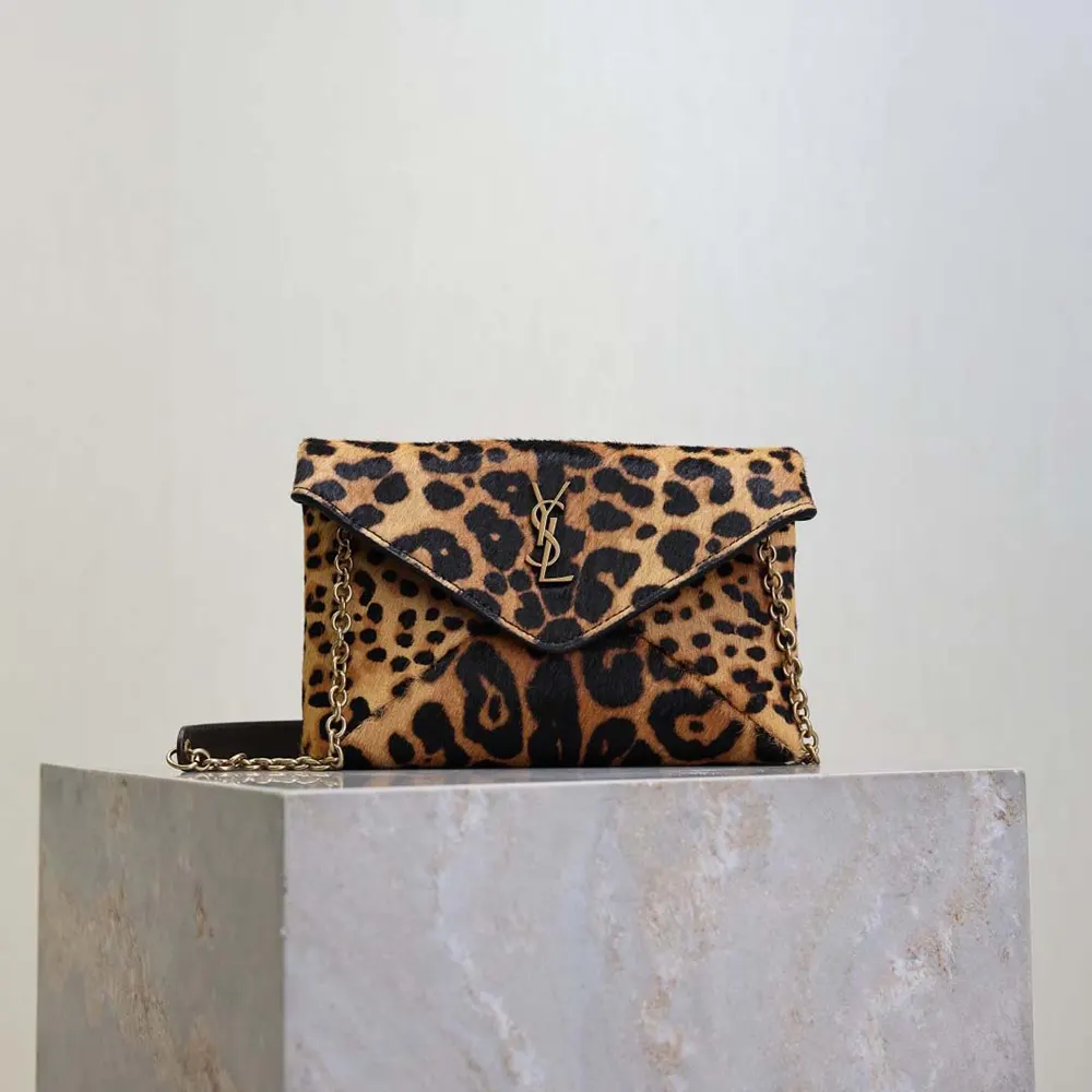 Close-up of gold YSL logo on Saint Laurent Cassandre Small Chain Pouch