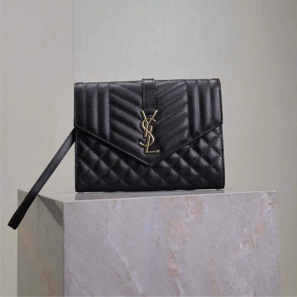 Close-up of YSL gold-tone hardware on black pouch leather