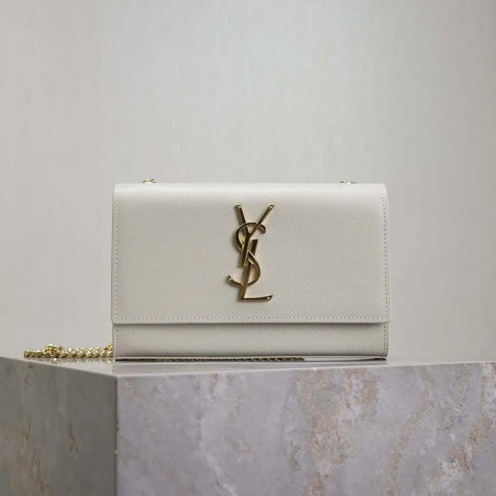 Close-up of gold YSL logo and Grain De Poudre embossed leather texture