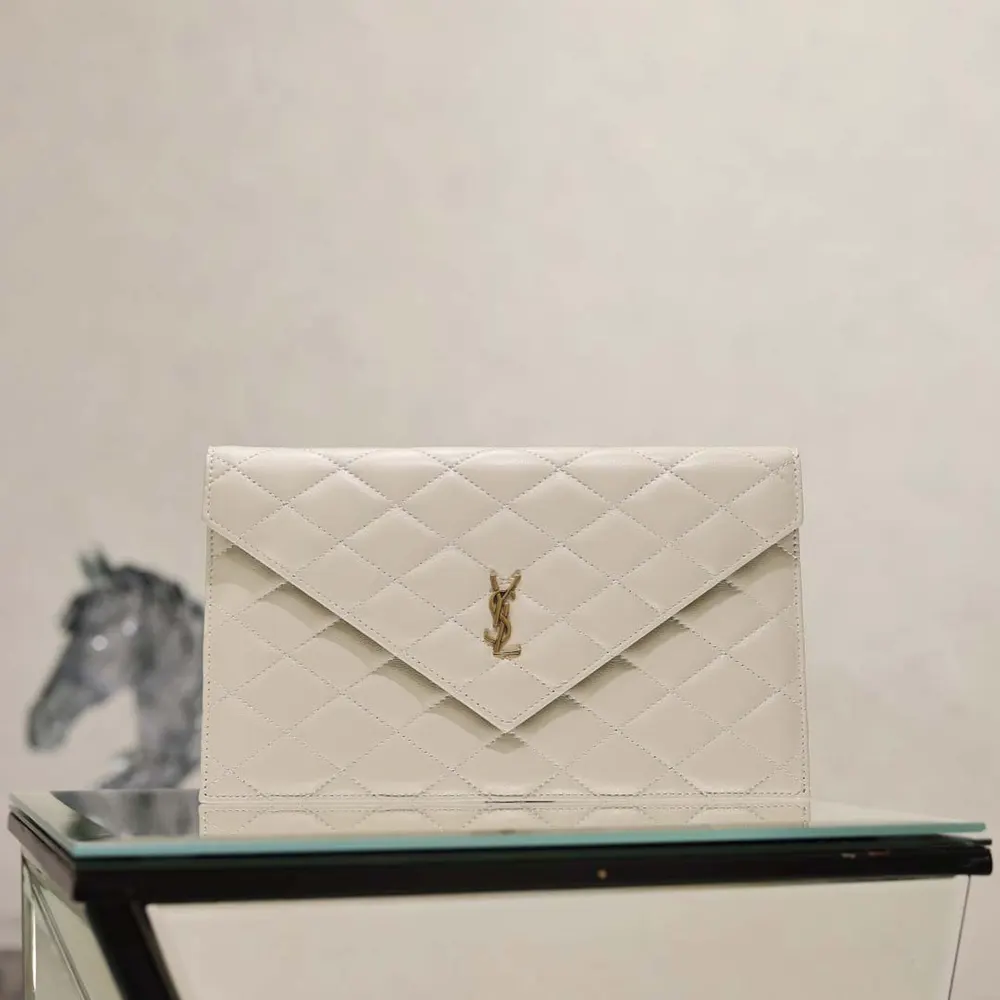 Close-up of gold YSL hardware on white lambskin pouch